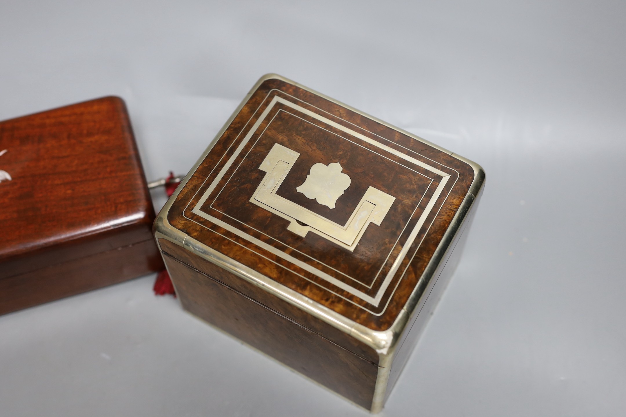 A 19th century Dutch amboyna and brass mounted tea caddy, 14 cm wide and a 19th century French mahogany box by Aucoc Aine a Paris